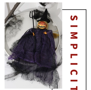 Detail of Halloween pumpkin witch hanging prop with purple mesh and black trident tool