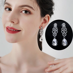 Macro detail of silver drop earrings with sparkling rhinestones for bridal weddings