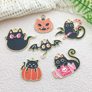 Detailed view of assorted Halloween enamel cat charms including pumpkin and bat styles