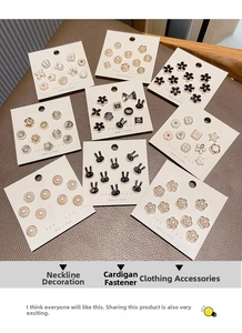 Detailed view of elegant pearl and gold enamel pins with floral and animal motifs