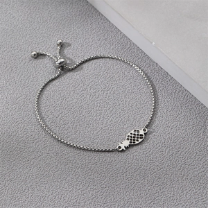 Detailed macro shot of adjustable silver box chain featuring a hollow pineapple charm