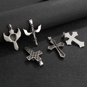 Close-up of gothic stainless steel pendants featuring lion heads, wings and crosses