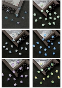 Star-shaped glass beads in various colors like purple, blue, and green for DIY jewelry