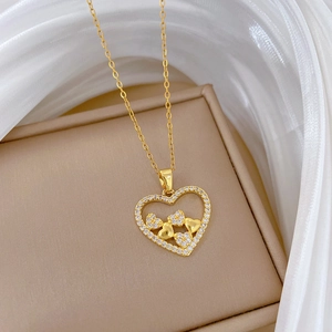 Elegant gold titanium steel heart necklace with sparkling crystals on jewelry box