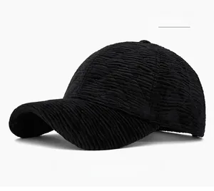 Detailed close-up showing the striped corduroy texture of the black winter baseball cap