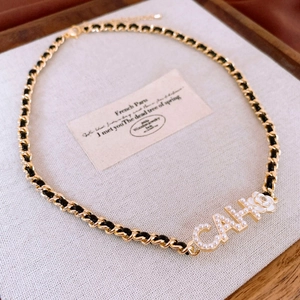Elegant gold chain necklace with white camellia flower and pearl-studded letter pendant