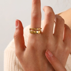 Minimalist double-layered gold stainless steel ring with hammered texture on model hand