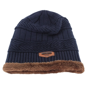 Detailed close-up of dark blue knit hat showing soft brown fleece lining and fine texture