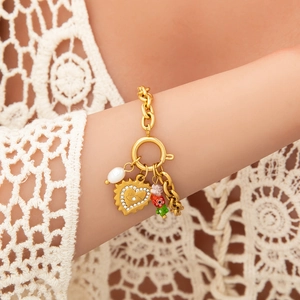 Detail of 18K gold plated chain necklace with pearl, heart pendant, and floral charms