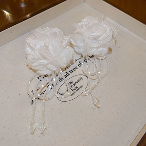 Detail of fabric flower earrings with pearl beaded tassels and crystal water drop charms