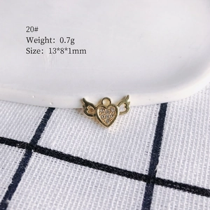 Macro shot of model 20# gold heart-shaped winged charm with rhinestones for DIY jewelry