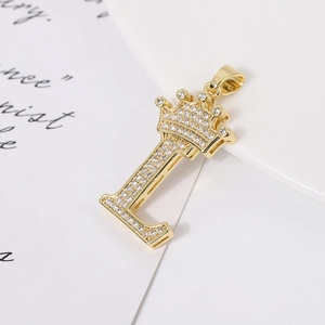 Macro shot of gold-plated letter L pendant with crown and micro-pave cubic zirconia