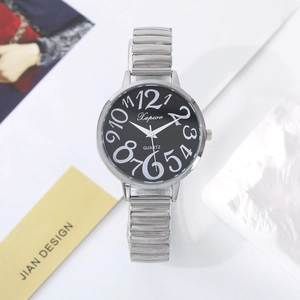 Detail of silver quartz watch with large numerals and elastic strap on minimalist background