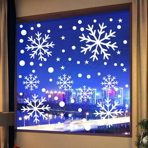 Detailed white snowflake window decals on glass with a beautiful night city view background