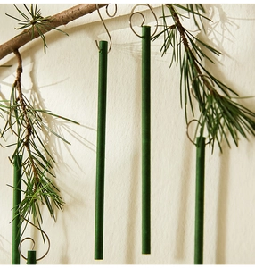 Macro view of slender pine-scented sticks hanging on natural Christmas tree branches