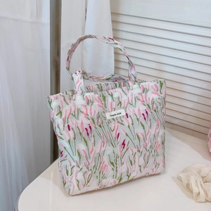 Sweet pink floral jacquard fabric tote bag with simple wish label on white desk