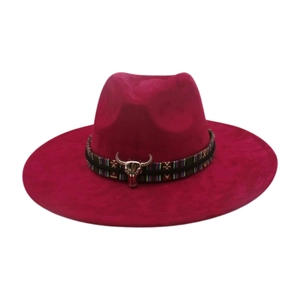Detail of deep pink wool felt fedora featuring ethnic woven band and silver bull head charm