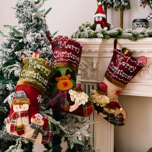 Three large Christmas stockings with 3D Santa, Snowman, and Reindeer hung by a fireplace
