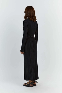Back view of a black long-sleeve knit dress showing vertical ribbed texture and tie detail