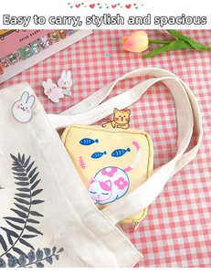 Cute yellow sanitary napkin storage bag with cat illustration tucked in a canvas bag