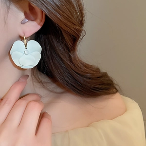 Detailed side view of mint green matte flower earrings with pearl and gold hook