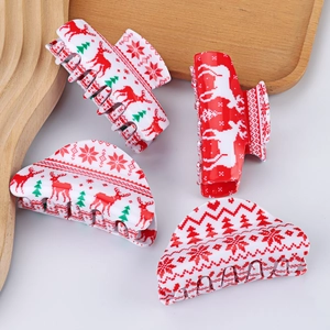 Christmas hair claw clips set with reindeer and snowflake patterns on white tray