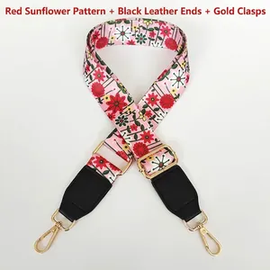 Detail of red sunflower floral strap with black leather ends and gold metal hooks