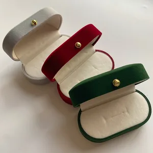 Three-color velvet jewelry boxes with oval shape and gold spherical button details