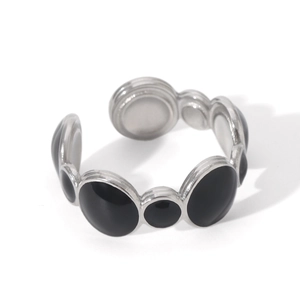Detail of adjustable silver stainless steel ring featuring black enamel inlay patterns