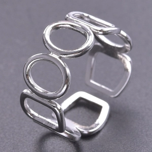 Close-up of silver hollow geometric open ring with alternating round and square patterns