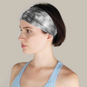 Close-up of a grey tie-dye sports headband worn by a model for yoga and fitness