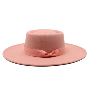 Detailed view of pink wool boater hat with matching bow ribbon and fine felt texture