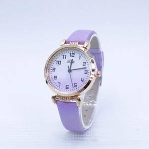 Detailed macro view of purple gradient dial with Arabic numerals on small leather watch