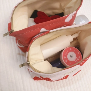 Top view of canvas cosmetic bag interior showing large capacity for makeup storage