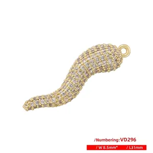 Detailed macro view of S-shaped chili pendant with gold plating and white zircon inlay