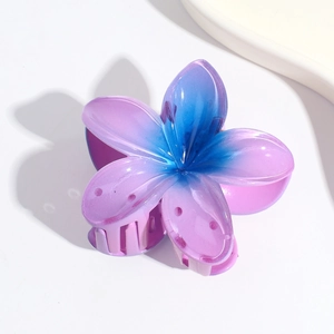 Detail of purple to blue gradient flower hair claw clip with glossy resin finish
