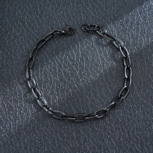 Professional close-up of a black stainless steel Cuban link bracelet with a lobster clasp.