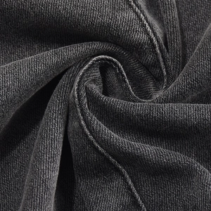 Detailed macro texture of dark grey stretch denim fabric with twill weaving patterns
