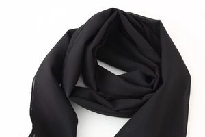 Detailed view of lightweight black chiffon scarf fabric with delicate stitched edges