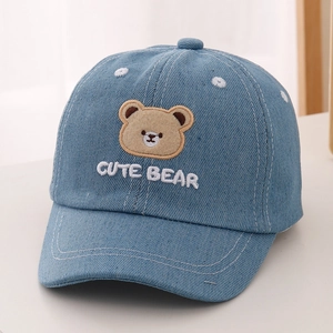 Close-up of cute bear embroidery and white CUTE BEAR text on light blue child cap