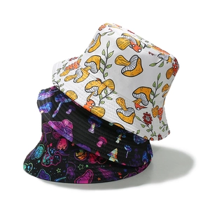 Three stacked reversible fisherman buckets hats with colorful mushroom prints on twill cotton