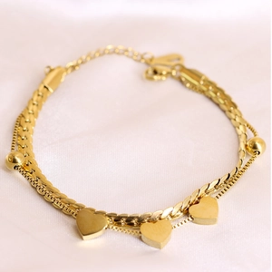 Detail of 18K gold-plated double-layer bracelet with heart charms and flat snake chain