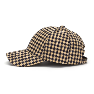 Close-up of the yellow and black houndstooth pattern on a stylish baseball cap