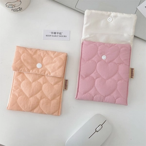 Close-up of heart-shaped quilted cotton pads pouches with secure snap button closure