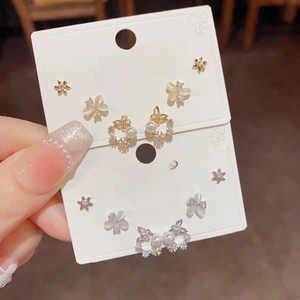 Close-up of S925 silver stud earrings set featuring zircon flowers and butterfly designs