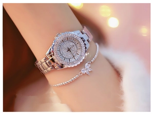 Close-up of sparkling silver rhinestone watch and elegant butterfly charm bracelet set