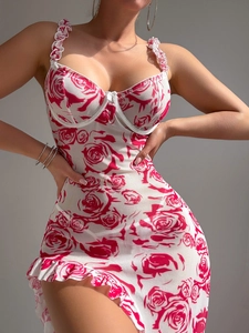 Detail of red rose print and ruffled hem on this sexy slim-fit slip dress for women