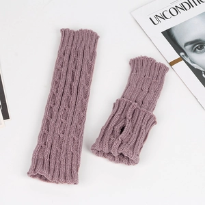 Detail of cable knit fingerless gloves in purple featuring thumb hole and soft acrylic texture