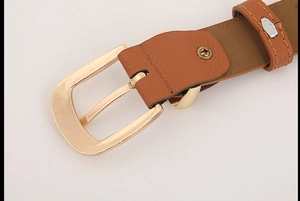 Close-up of brown litchi pattern leather belt with a polished gold alloy pin buckle