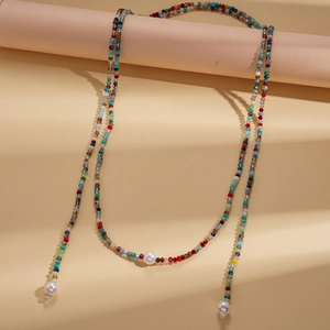 Bohemian colorful glass beaded long necklace with white pearls on a minimalist warm display